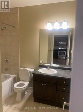 Woodstock (Woodstock - South) condo for rent - A bathroom with a toilet, sink, and tub.