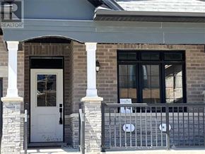 Uxbridge townhouse for rent - A house with a white door and a window with a black frame.