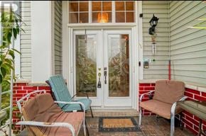 Brampton (Northwest Sandalwood Parkway) apartment for rent - A white door with glass panels is flanked by two chairs.
