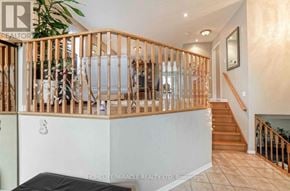 Brampton (Northwest Sandalwood Parkway) apartment for rent - A living room with a staircase and a couch.