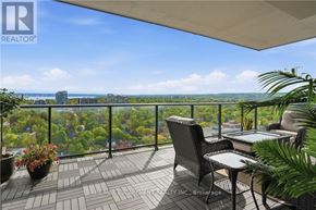 Burlington (Brant) condo for rent - A balcony with a table and chairs overlooking a cityscape.