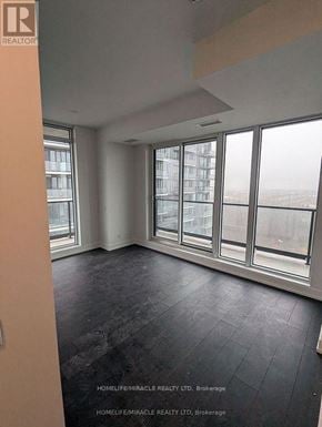 Brampton (Northwest Brampton) condo for rent - A room with a large window and a wooden floor.