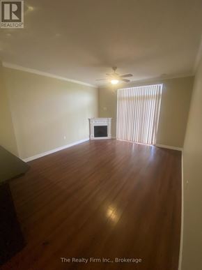 Woodstock (Woodstock - South) condo for rent - A room with wooden floors and a fireplace.