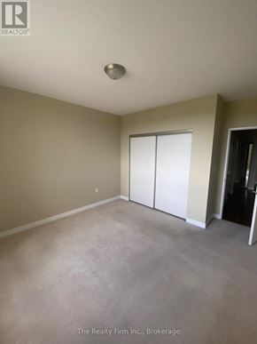 Woodstock (Woodstock - South) condo for rent - A room with a sliding door and a ceiling light fixture.