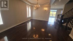 Vaughan (Patterson) apartment for rent - A spacious room with wooden floors and a chandelier.