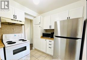 Mississauga (Erin Mills) house for rent - A kitchen with white cabinets and a stainless steel refrigerator.