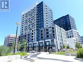 Richmond Hill (South Richvale) condo for rent - A modern multi-story building with a glass facade is the main focus of the image.
