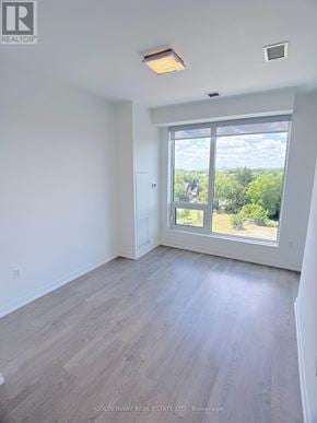 Richmond Hill (South Richvale) condo for rent - A room with a sliding glass door leading to a green landscape.