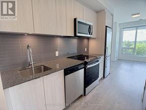 Richmond Hill (South Richvale) condo for rent - A kitchen with a sink, stove, and refrigerator.