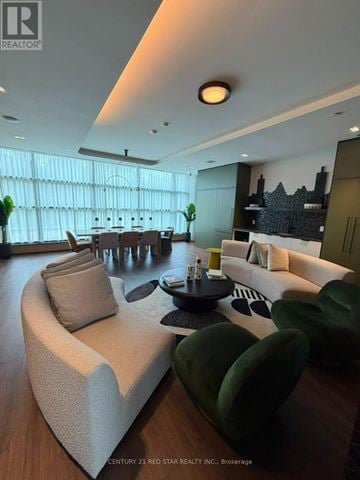 Milton (Cb Cobban) condo for rent - A modern living room with a large sofa and a coffee table.