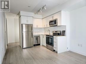 Toronto (Humber Heights) condo for rent - A kitchen with white cabinets and stainless steel appliances.