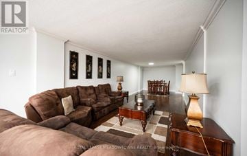 Guelph (Downtown) condo for rent - A living room with a brown couch and a coffee table.