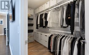 Toronto (Niagara) condo for rent - A well organized walk in closet with clothes hanging on shelves and drawers.