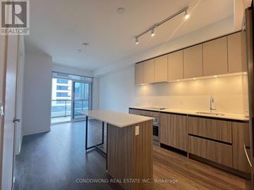 Vaughan (Beverley Glen) condo for rent - A kitchen with wooden cabinets and a countertop is shown.