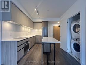 Vaughan (Beverley Glen) condo for rent - A modern kitchen with a washer and dryer in the laundry room.