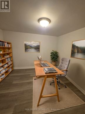 Barrie (North Shore) multi-family for rent - A room with a desk, chair, and bookshelf.