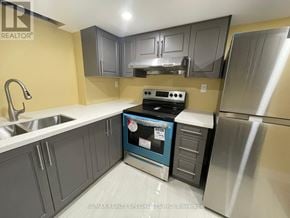 Mississauga (Central Erin Mills) apartment for rent - A kitchen with a stove top oven and a refrigerator.