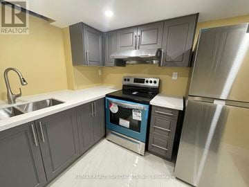 Mississauga (Central Erin Mills) apartment for rent - A kitchen with a stove top oven and a refrigerator.
