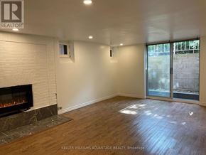 Toronto (Casa Loma) multi-family for rent - A room with a fireplace and a sliding glass door.