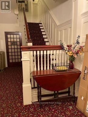 Toronto (Casa Loma) multi-family for rent - A wooden table with a basket of flowers on top of it.