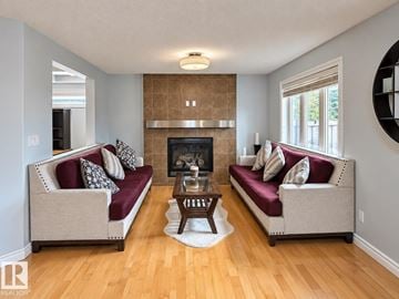 Edmonton apartment for rent - A living room with two couches and a fireplace.