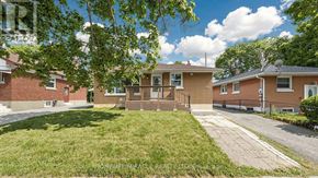 Oshawa (Donevan) apartment for rent - A sunny day at a residential area with houses and green lawns.