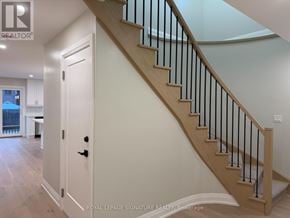 Mississauga (Fairview) apartment for rent - A staircase with a black railing and wooden steps.