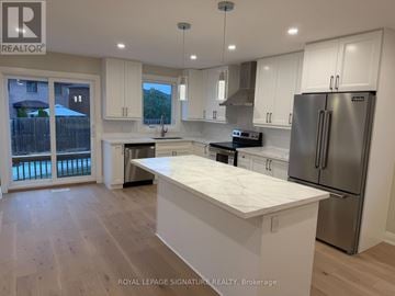 Mississauga (Fairview) apartment for rent - A kitchen with white cabinets and a marble island.