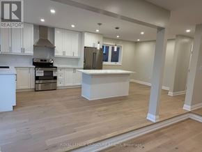Mississauga (Fairview) apartment for rent - A kitchen with white cabinets and a wooden floor.