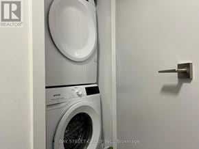 Toronto (Cabbagetown-South St. James Town) condo for rent - A white washing machine and dryer in a small laundry room.