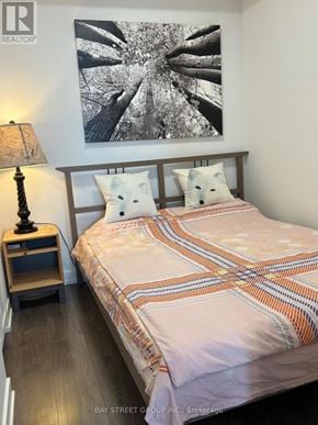 Toronto (Cabbagetown-South St. James Town) condo for rent - A bedroom with a bed, a lamp, and a picture on the wall.