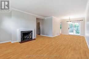 Mississauga (Lakeview) apartment for rent - A large, empty room with a fireplace and wood flooring.