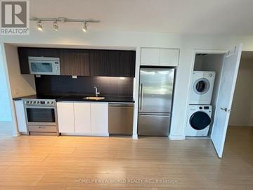 Toronto (Waterfront Communities) condo for rent - A modern kitchen with a stainless steel refrigerator, oven, and microwave.