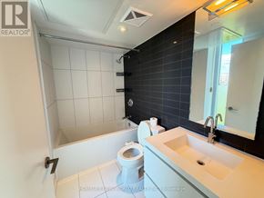 Toronto (Waterfront Communities) condo for rent - A bathroom with a toilet, sink, and a shower.