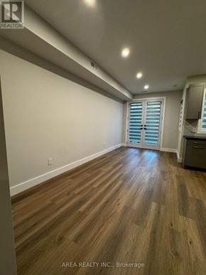 Toronto (Oakwood Village) triplex for rent - A room with wooden flooring and a window with shutters.