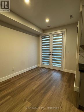 Toronto (Oakwood Village) triplex for rent - A room with wooden flooring and a sliding door with blinds.