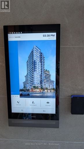 Oakville (Jm Joshua Meadows) condo for rent - A tablet displaying a real estate website with a building image and navigation buttons.