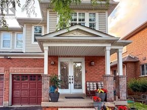 Brampton (Fletcher's Meadow) apartment for rent - A house with a red garage door and a white front door.