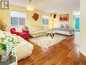 Brampton (Fletcher's Meadow) apartment for rent - A living room with a white couch and a red chair.