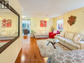 Brampton (Fletcher's Meadow) apartment for rent - A living room with white furniture and a rug.