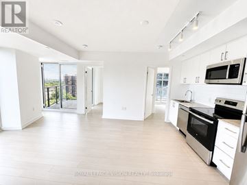 Toronto (Humber Heights) condo for rent - A spacious kitchen with white cabinets and stainless steel appliances.