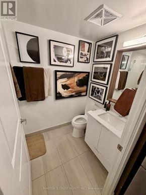 Toronto (Waterfront Communities) condo for rent - A bathroom with a white tub, toilet, and sink.