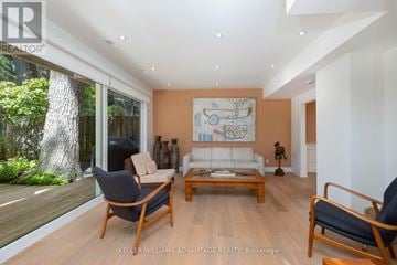 Toronto (The Beaches) apartment for rent - A living room with a white couch and a wooden coffee table.