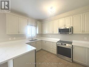 Vaughan (Vellore Village) apartment for rent - A kitchen with white cabinets and a stove top oven.