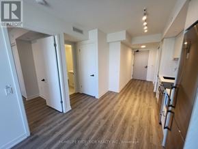 Vaughan (Vaughan Corporate Centre) condo for rent - A spacious room with wooden flooring and white walls.