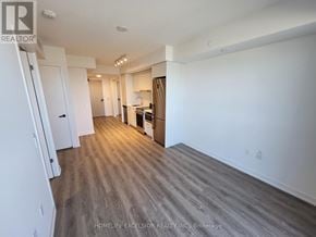 Vaughan (Vaughan Corporate Centre) condo for rent - A spacious living room with wood flooring and white walls.