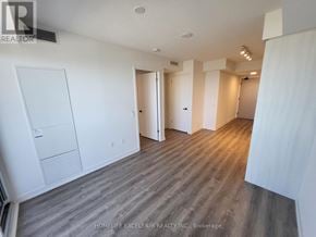 Vaughan (Vaughan Corporate Centre) condo for rent - A spacious room with wooden flooring and white walls.