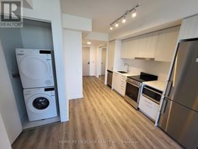 Vaughan (Vaughan Corporate Centre) condo for rent - A modern kitchen with stainless steel appliances and wooden flooring.