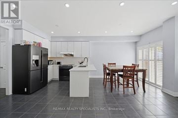 Bradford West Gwillimbury (Bradford) apartment for rent - A modern kitchen with a dining table and chairs.