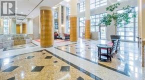 Toronto (Bay Street Corridor) condo for rent - A lobby with a marble floor and pillars.